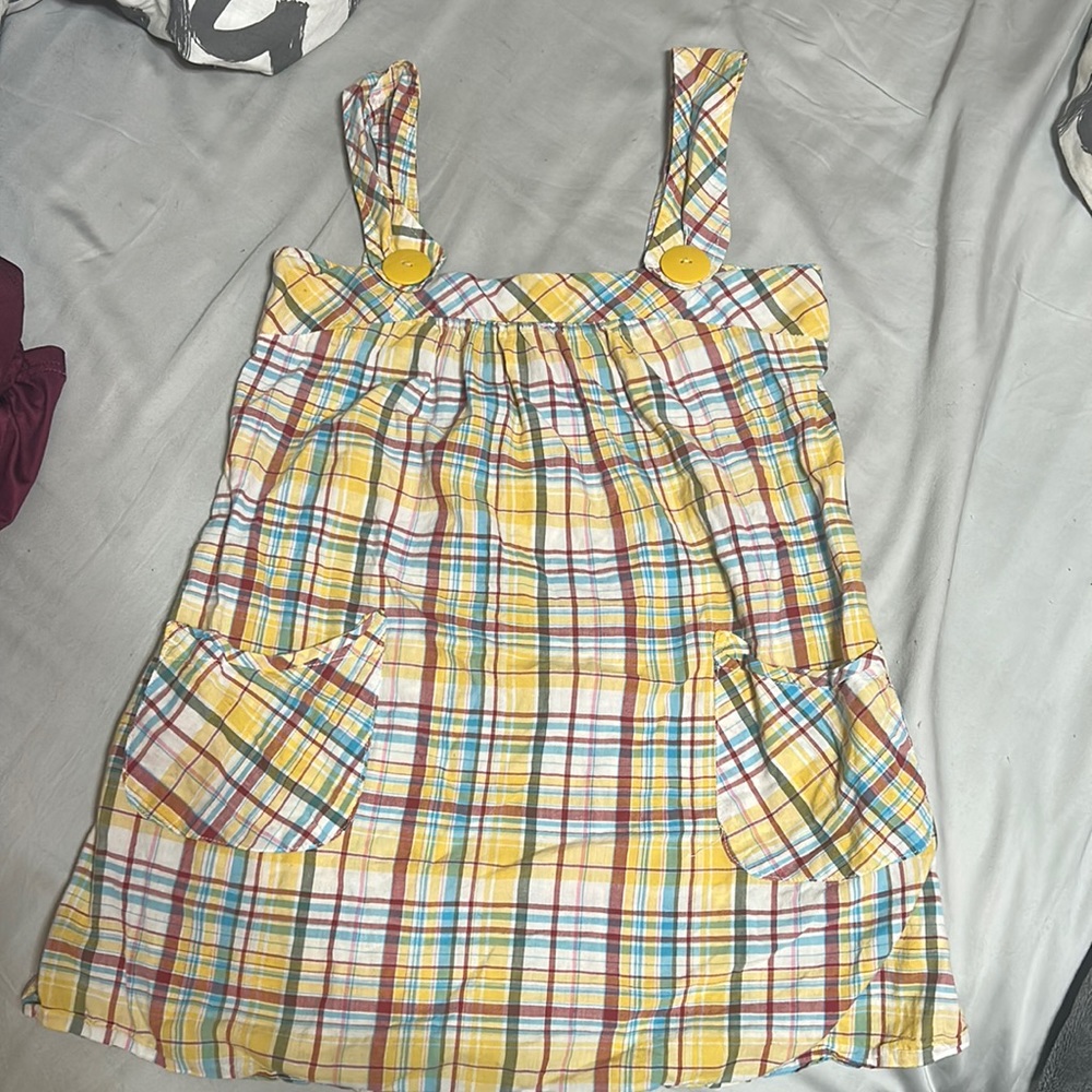 It’s a plaid tank top, yellow, red, green, blue, and white in a xs